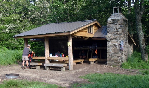 Double Spring Gap Shelter sits right on the Appalachian Trail with a grassy area in front. Great Smoky Mountains National Park