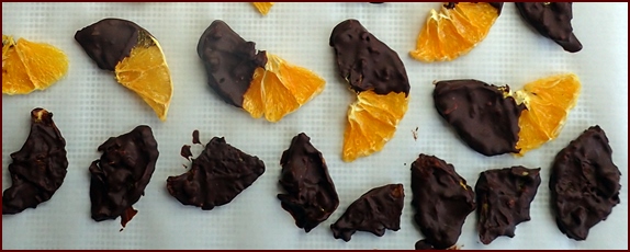 chocolate covered oranges, some fully coated rather than dipped.