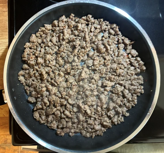 Cooking sausage-seasoned ground beef.