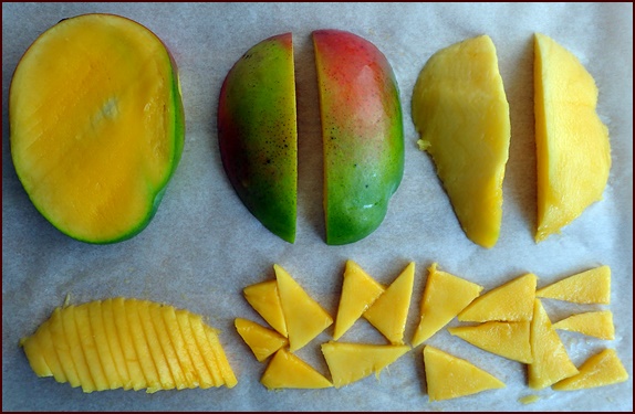 Photo shows a mango cut crosswise into triangular-shaped pieces.