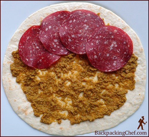Olive paste on tortilla with meat. Two tablespoons is a good amount.