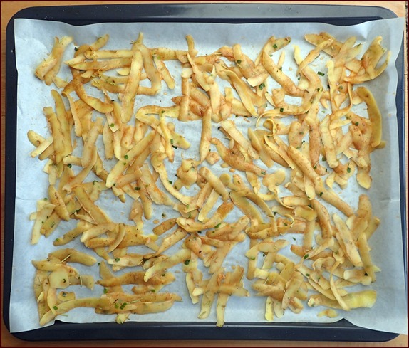 Baking seasoned potato skins in the oven before dehydrating.