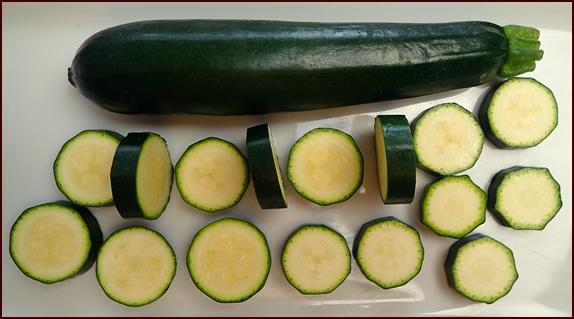 Cutting zucchini into thick chips.