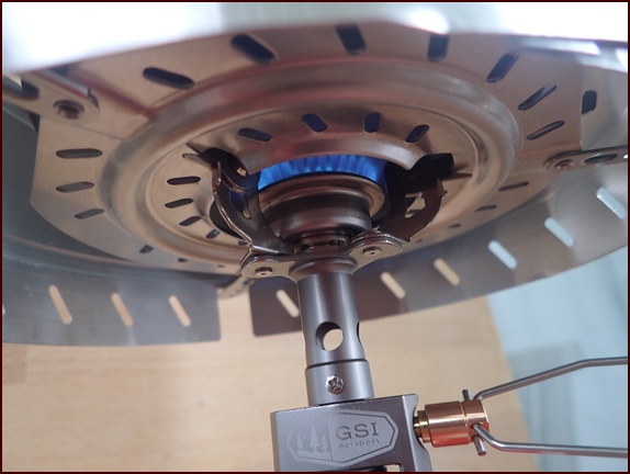 GSI Pinnacle Canister Stove flame lit with windscreen.