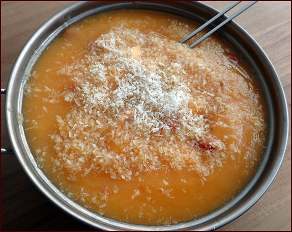 Photo shows one serving of Mango-Berry Fruit Pudding with Shredded Coconut.