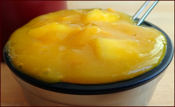 Photo shows one of two servings of a Ginger-Mango Spoon Smoothie with Pineapple.