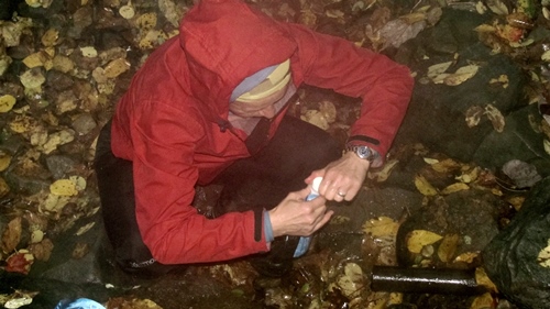 Dominique filling Sawyer squeeze bags at a water source in Shenandoah National Park.