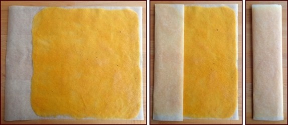 Folding mango fruit leather in baking paper for storage and transport.