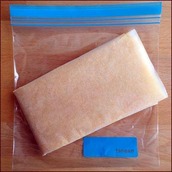 Photo shows one folded sheet of mango fruit leather.