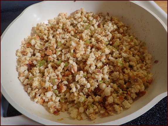 Breadcrumbs and vegetables combined in pan.