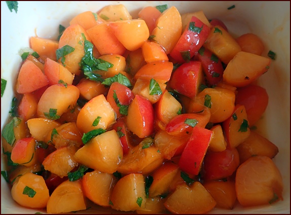 Cut apricots with mint for apricot salsa recipe.