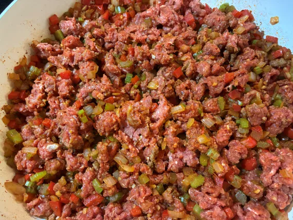 Ground beef added to cooked vegetables. Ground beef added to cooked vegetables.