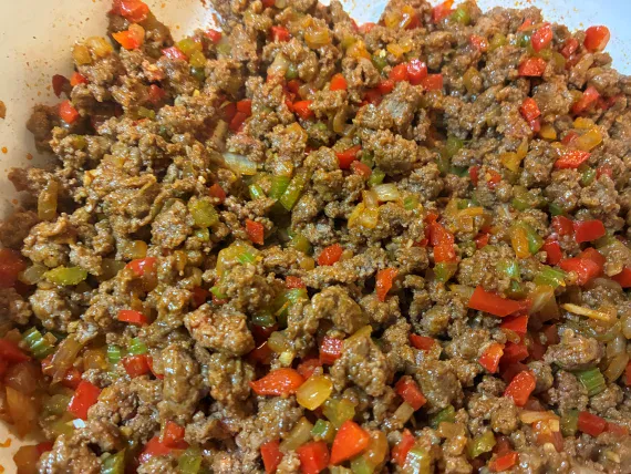 Ground beef after browning with vegetables. Ground beef after browning with vegetables.
