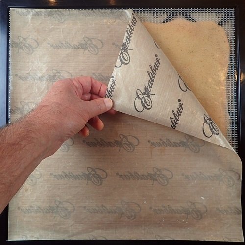 Flip trick: Peeling away the nonstick sheet from fruit leather after flipping it over.