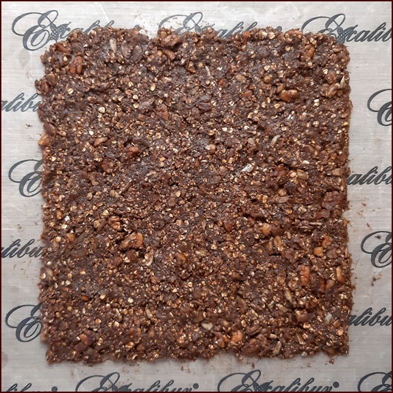 Spread energy bar mixture .25 inch thick on nonstick sheet.
