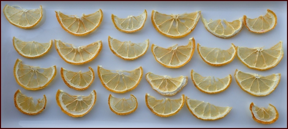 Slice lemons thinly and cut in half for fastest dehydration.