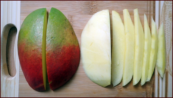Photo shows a mango cut longwise into longer strips.