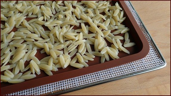 Orzo cooked like pasta on silicone dehydrator tray.