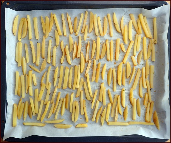 Fry-cut potatoes on baking tray for oven.