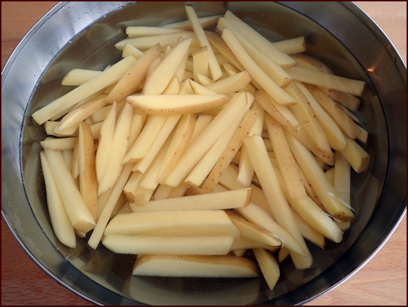 Soaking fry-cut potatoes after cutting.
