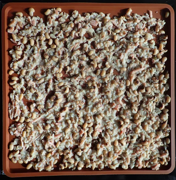 Two cups of cooked Hoppin’ John on silicone tray. Two cups of cooked Hoppin’ John on silicone tray.