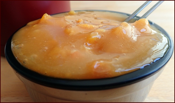 Photo shows one of two servings of a Raspberry-Mango Spoon Smoothie with Orange.