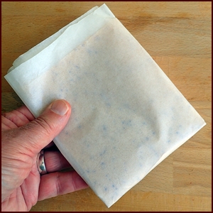 Nectarine fruit leather folded in parchment paper.