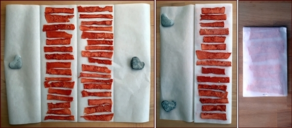 Packing dehydrated watermelon by folding it in parchment paper.