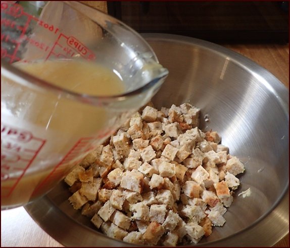 Pouring gravy over the turkey loaf cubes.