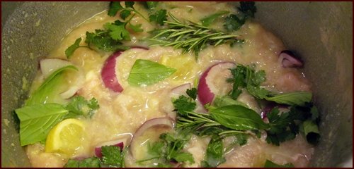 Aromatic ingredients in the pressure cooker with the chicken and potato-thickened liquid.