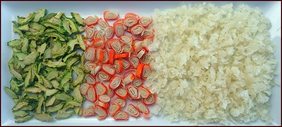 Dried ingredients used to make a cold-soak sushi rice bowl salad: dehydrated cucumber, surimi, and sushi rice.